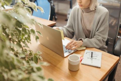 Female sitting at her laptop on a table 