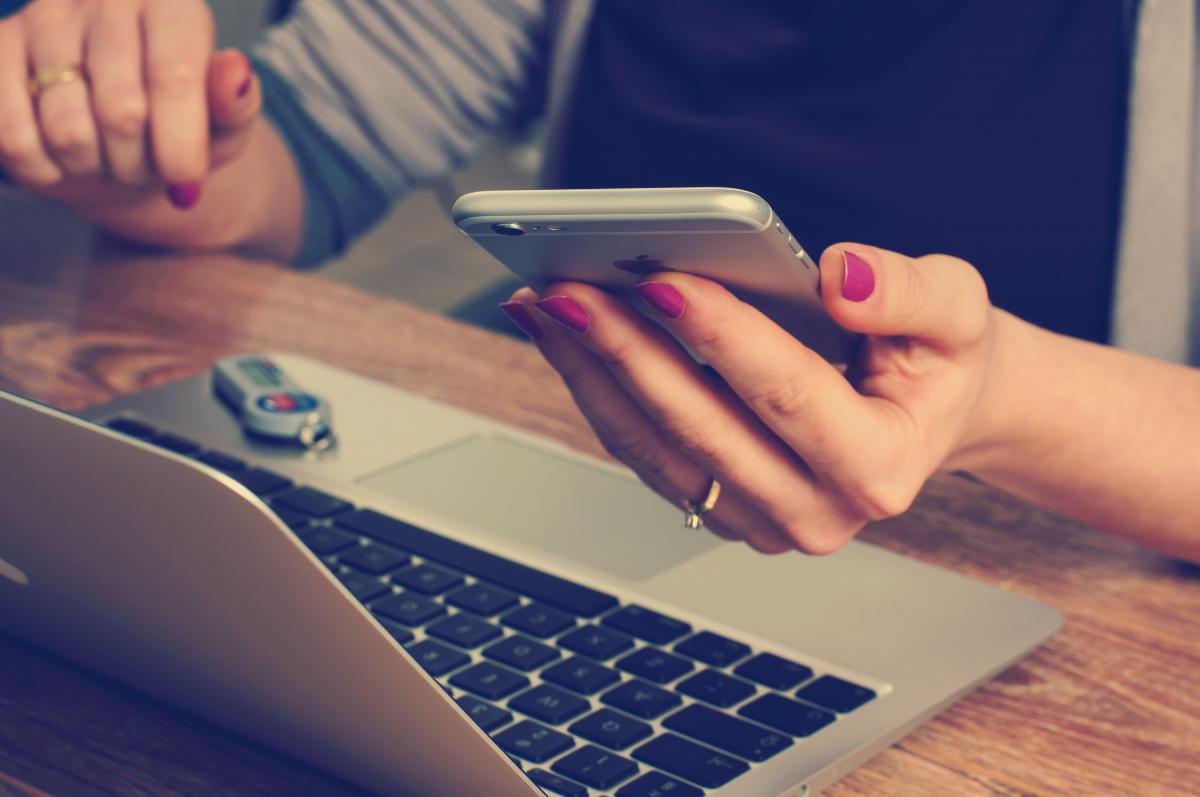 Holding phone while also using laptop